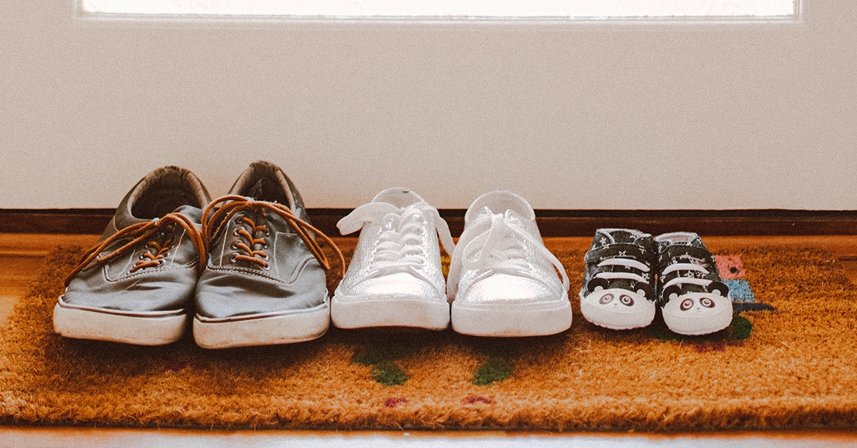 Taking over a family business? What's involved in the successful transfer of the family business. Picture of three pairs of shoes belonging to a family.