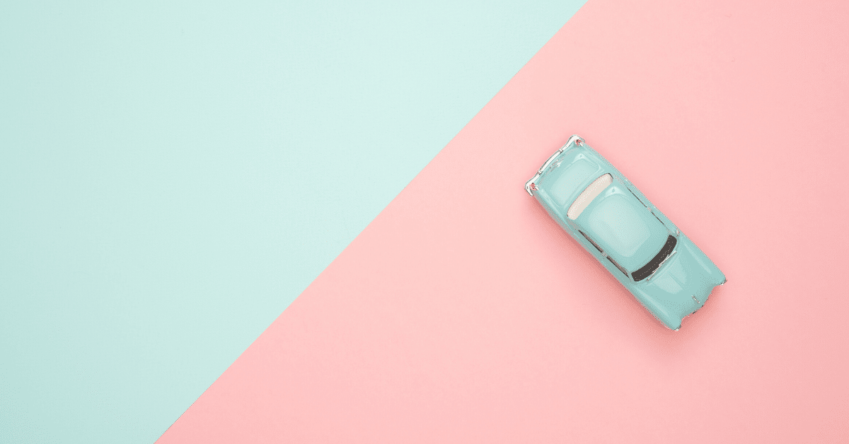 IRS Mileage Reimbursement - image of blue car on a blue and pink background