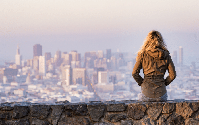 Preparing for Year-End and Tax Season - a woman looks out at a skyline - are you prepared for the year ahead?