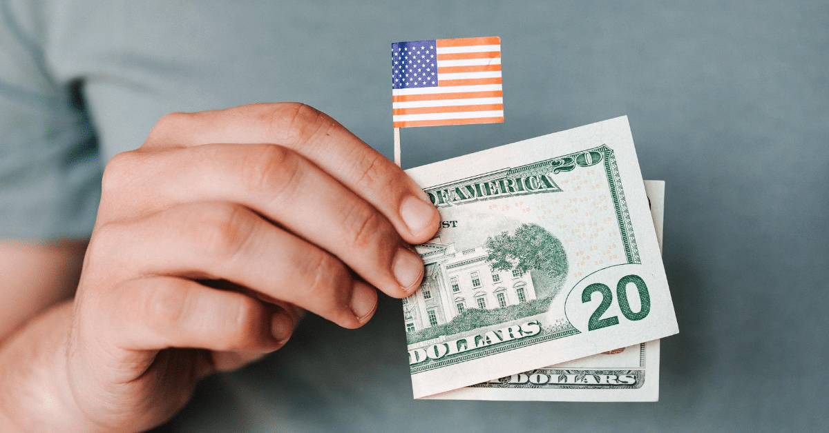 Executive Orders from August 8, 2020 - Chortek Tax Update - Picture of a hand holding a $20 bill and a small American flag