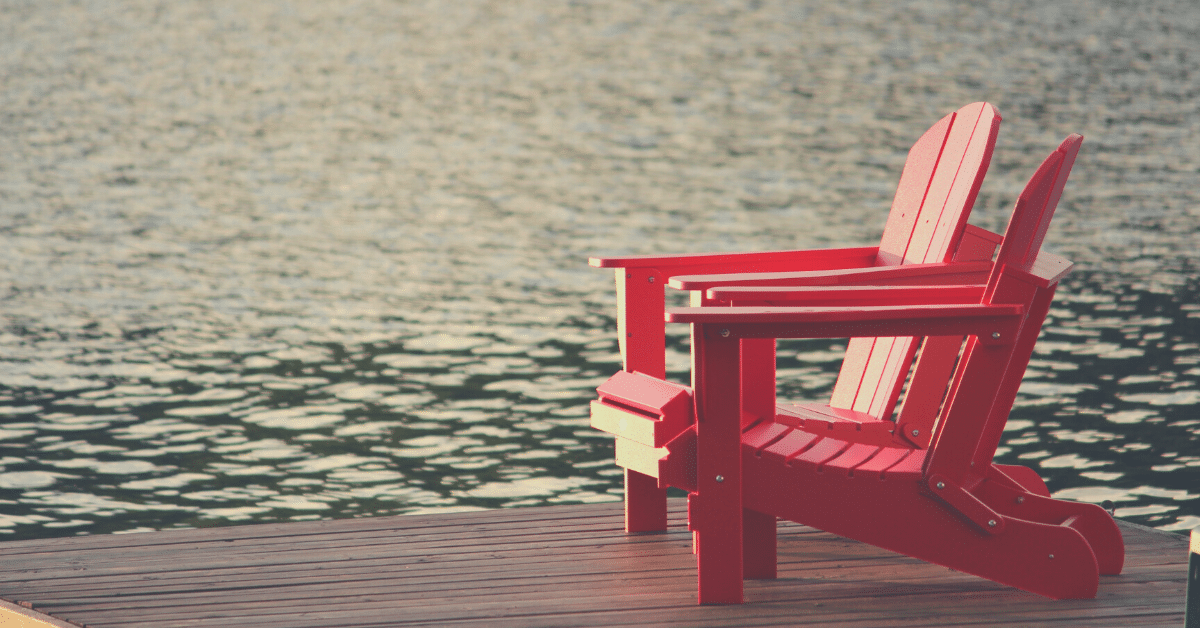 What is the SECURE Act? Image of two red lounge chairs outside on a dock surrounded by water
