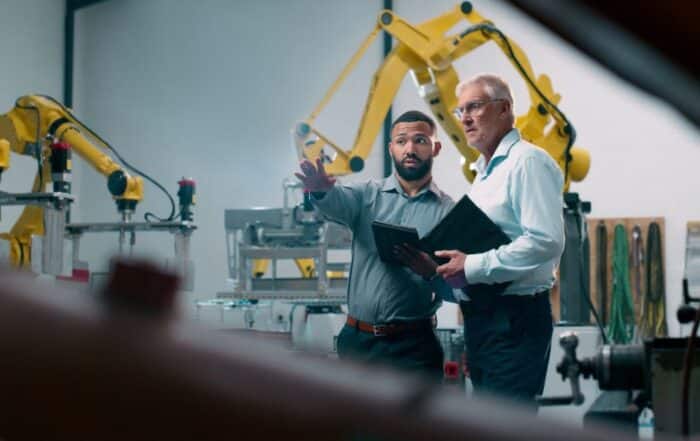 Two businessmen talking in a modern manufacturing facility